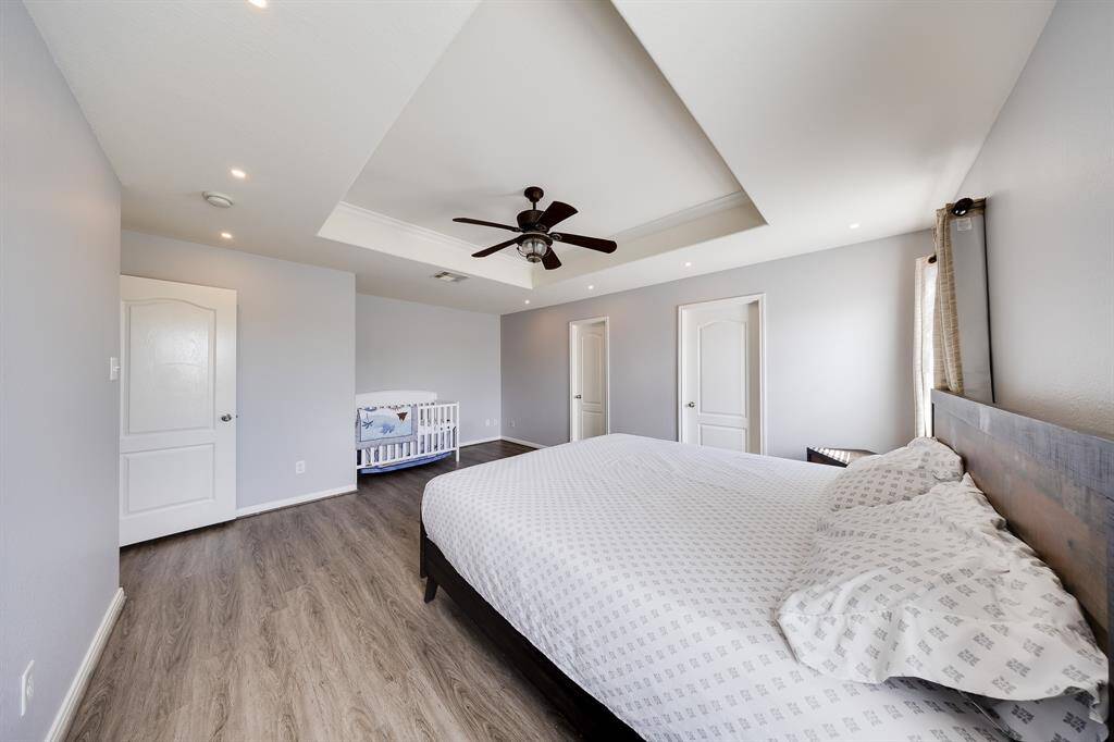 Master suite with ample space, recessed lighting, and crib area for flexibility.