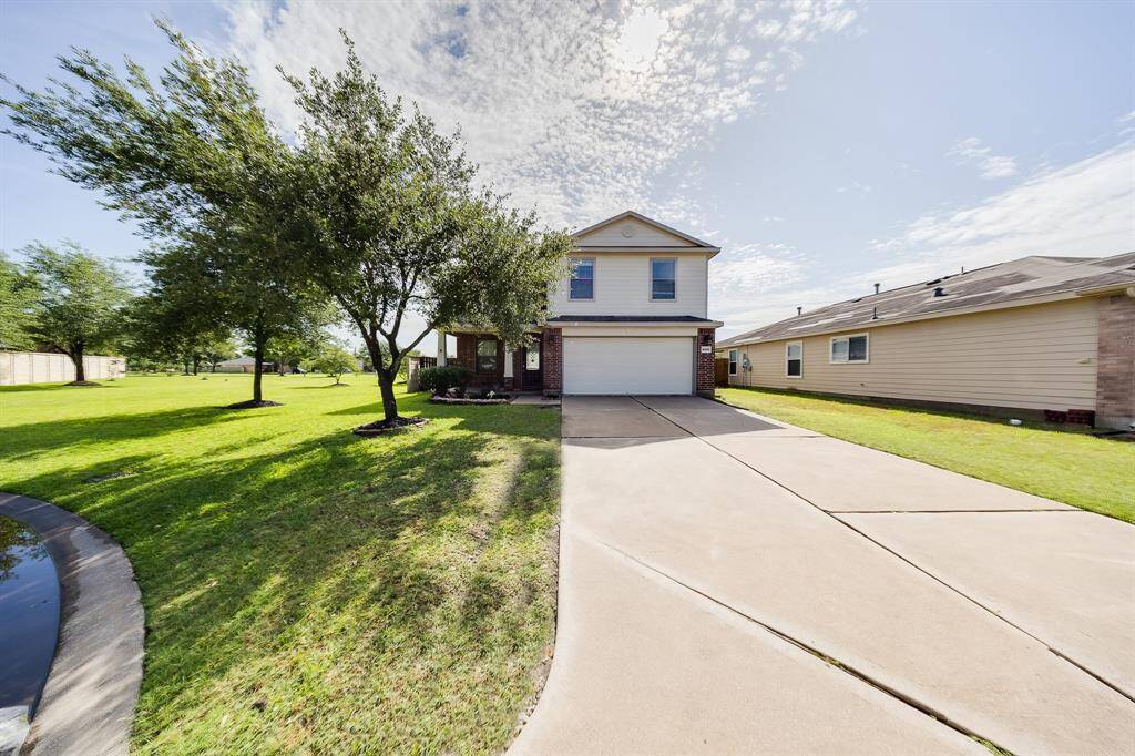 Showcase-wide view highlights corner lot, curb appeal, and extra green space wrapping around the property.
