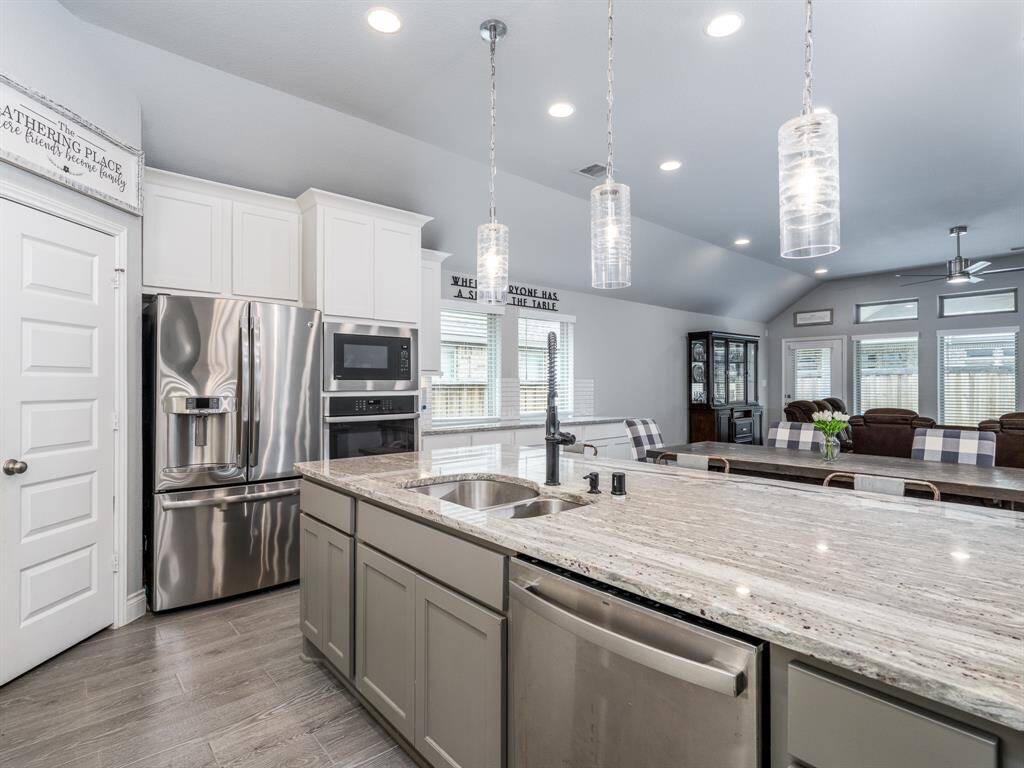 Kitchen features include an enormous granite island, stainless appliances and a walk-in pantry.