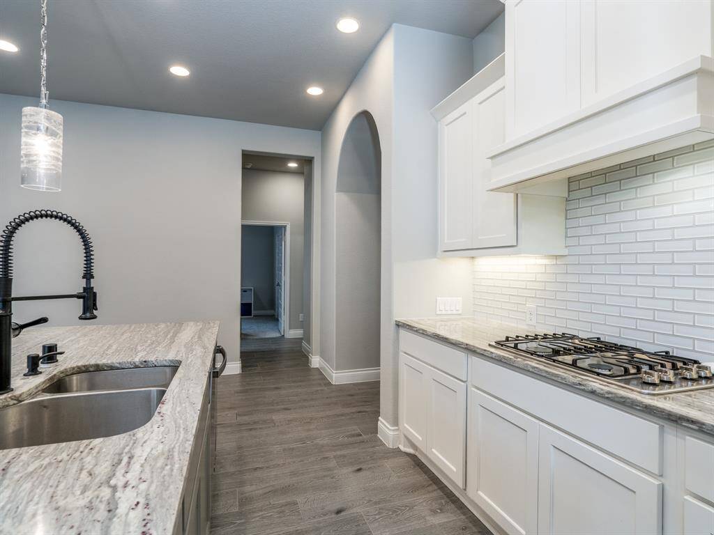 Undermount stainless sink and industrial styled faucet.