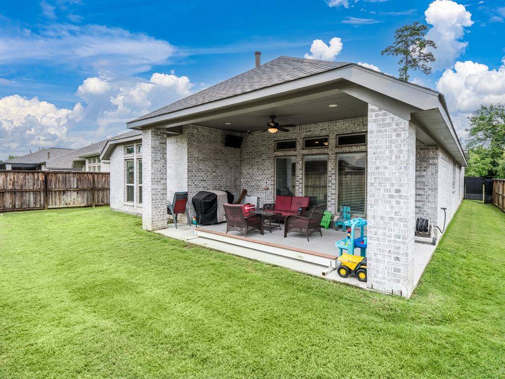 Large covered back porch perfect for summer BBQ and grilling.