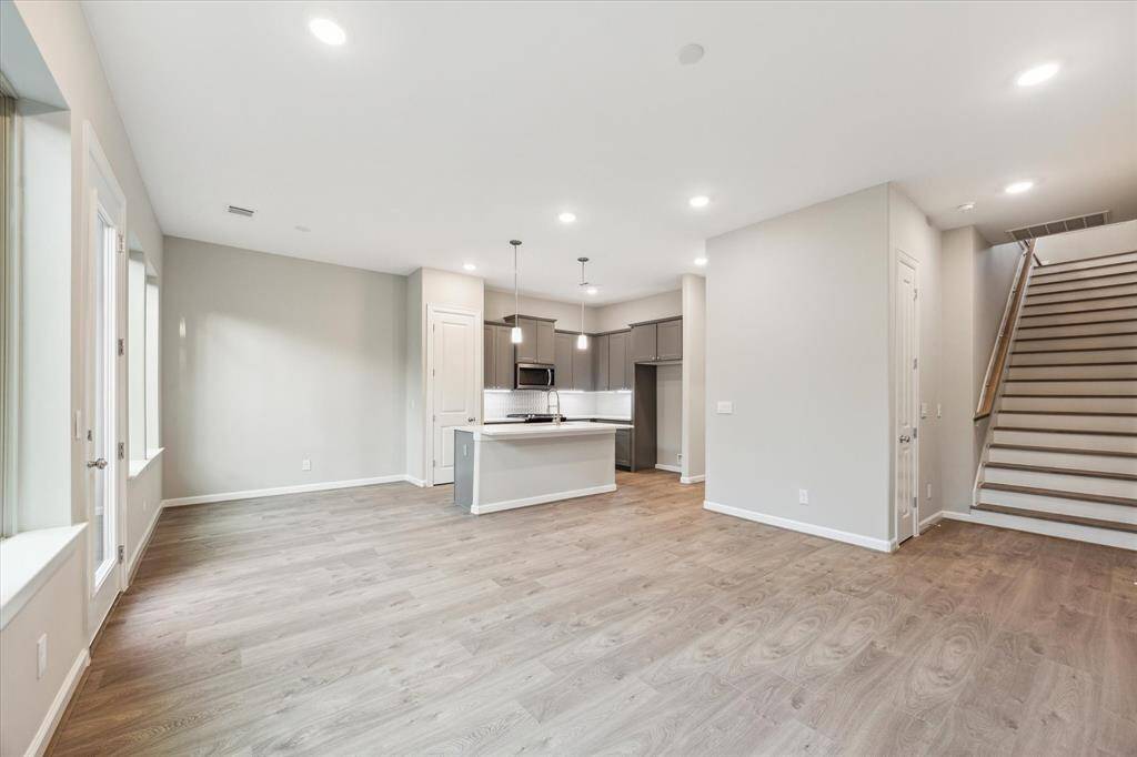 Spacious and bright with luxury vinyl plank floors, recessed lighting, and large windows offering abundant natural light.