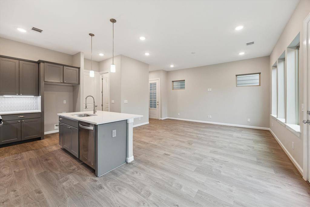 Flow seamlessly from living to dining to kitchen in this open-concept layout perfect for entertaining. Designer lighting and finishes throughout.