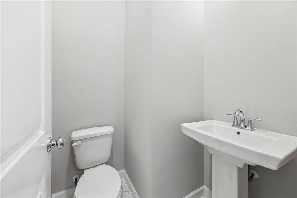 The powder room with contemporary fixtures and neutral finishes.