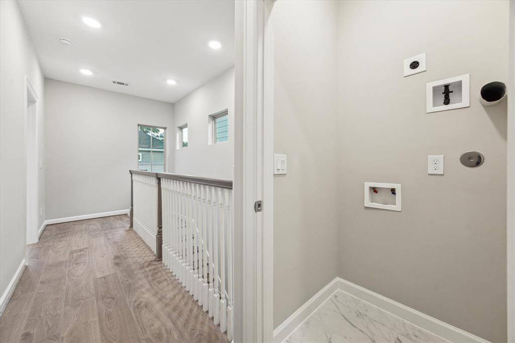 Convenient upstairs location with ceramic tile floor and connections for full-size washer and dryer.