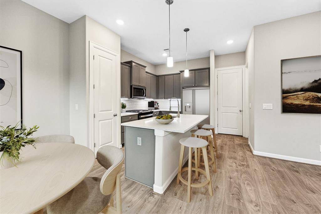 Features sleek quartz countertops, soft-close cabinetry, and a stylish tile backsplash. Stainless steel appliances and a large island make it ideal for cooking and entertaining.