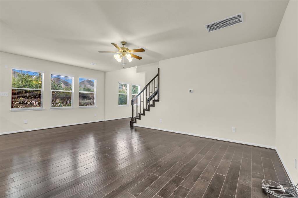 reshly painted interior with beautiful flooring, a lovely kitchen, and plenty of windows for natural light