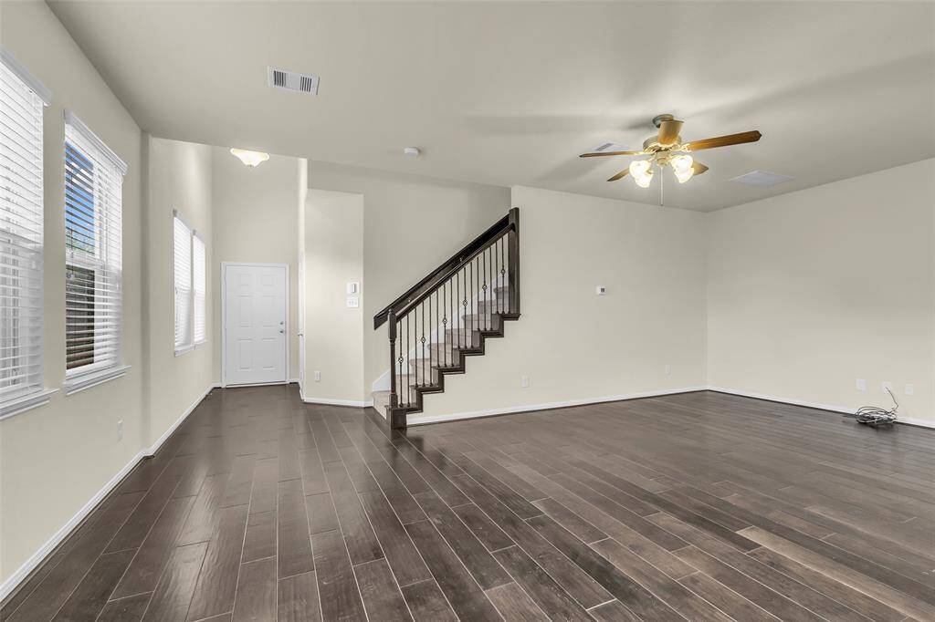 reshly painted interior with beautiful flooring, a lovely kitchen, and plenty of windows for natural light!