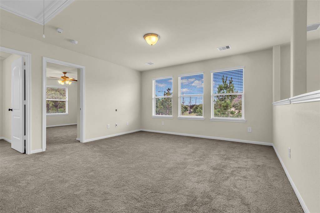 Upstairs features a spacious flex room or game room, open to two additional bedrooms and a full bathroom—all with brand-new carpet throughout.