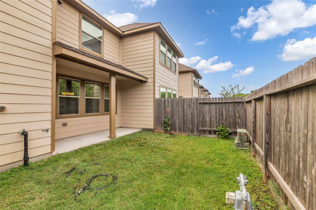 he backyard features a porch perfect for relaxing and entertaining!