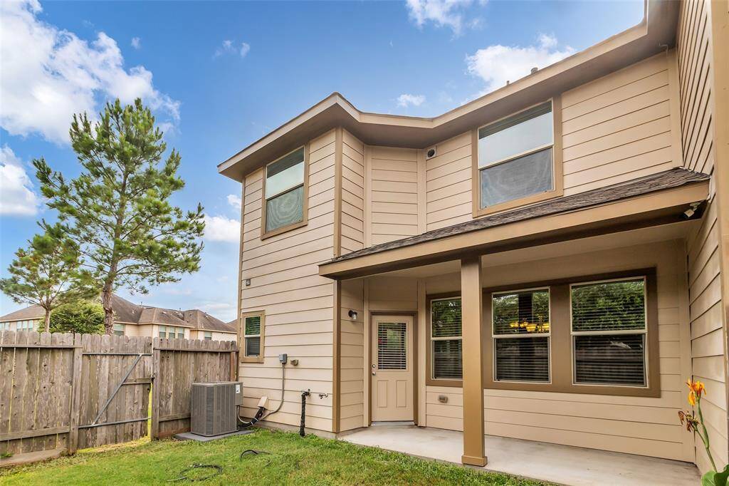 The backyard features a porch perfect for relaxing and entertaining, with direct access through the fence to an open park located on the right side of the home