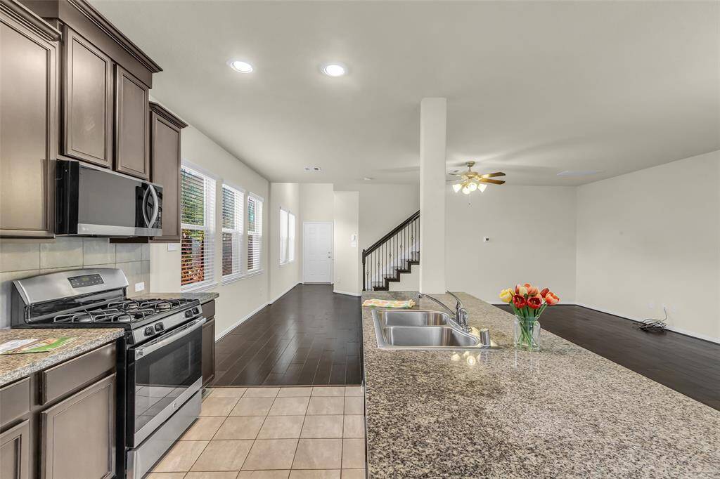 Lovely kitchen featuring a granite island!