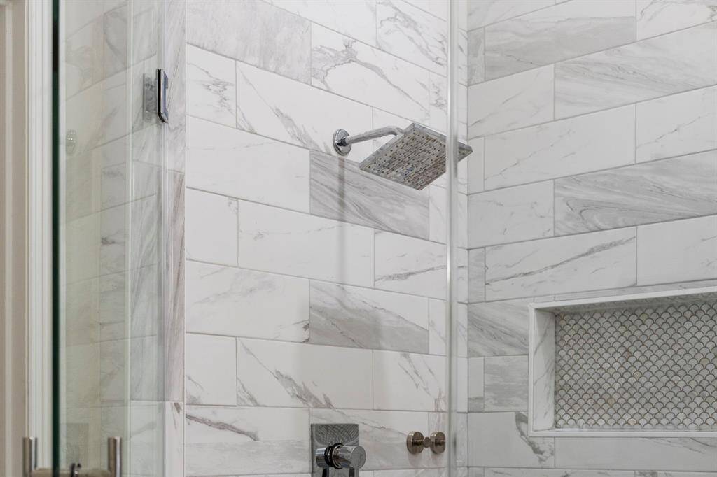 The walk-in shower has modern finishes.