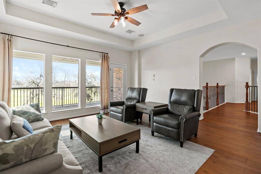 Right upstairs the game room features beautiful floors, high ceilings, ceiling fan, and access to the balcony that overlooks your private backyard oasis.