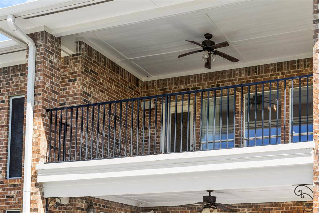 The covered balcony is perfect for a sitting area and has an outdoor ceiling fan.