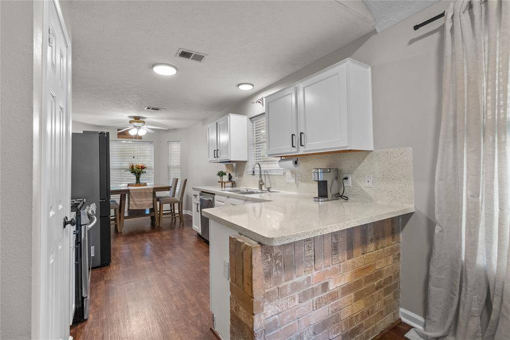 Whip up your favorites in this charming kitchen with this cute aesthetic! Exposed brick, spaciou countertops, and a cozy layout complete with a breakfast nook.