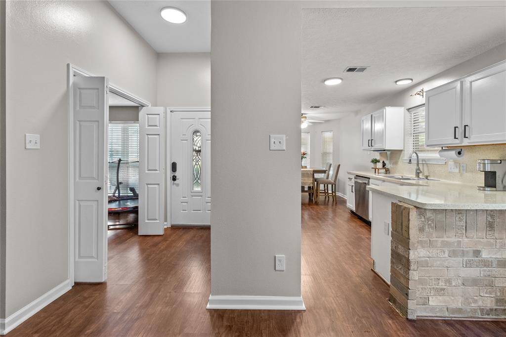 A peek from the living room reveals the home's thoughtful layout — with a versatile flex space just off the entry and the kitchen and breakfast nook tucked around the corner for easy flow and function.