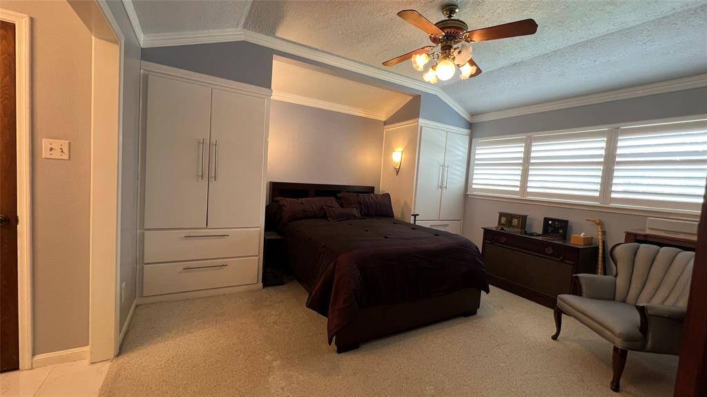 Primary has vaulted ceilings and plantation shutters throughout the home.