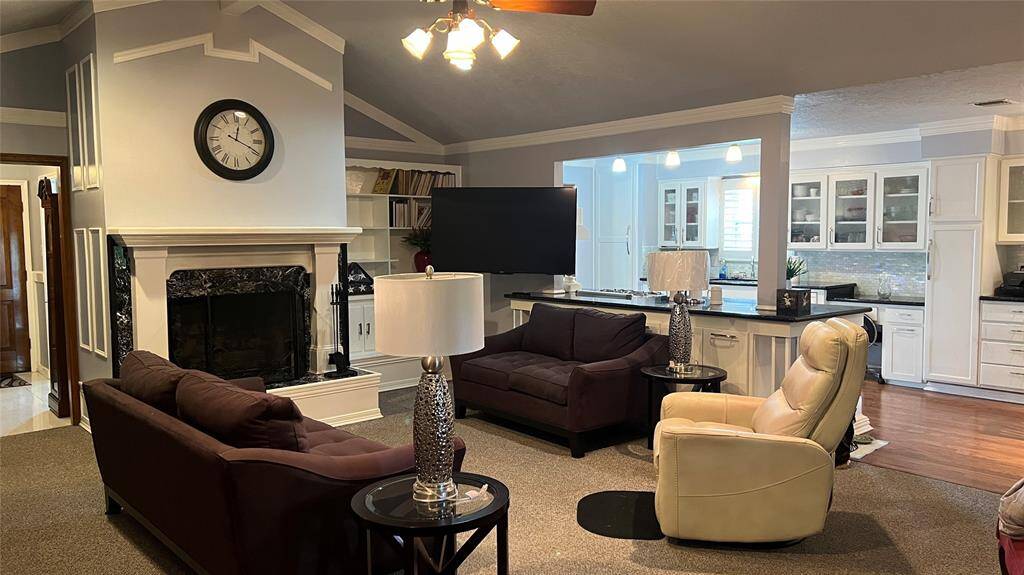 Vaulted ceiling in living room...gas log fireplace...built-in bookshelf and cabinets!