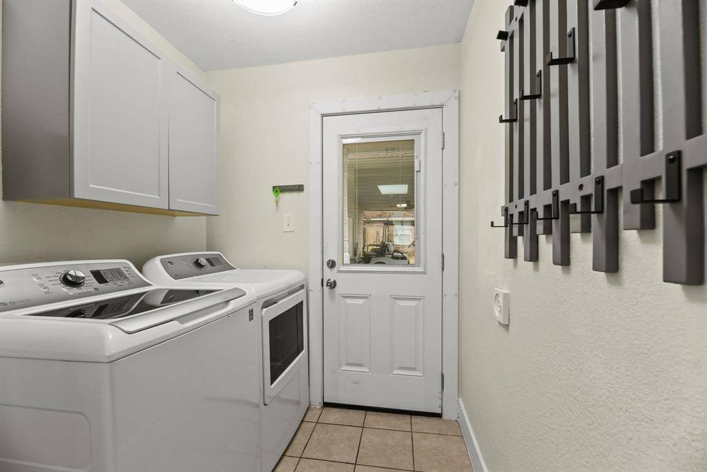 Laundry room/mud room is conveniently located by the back door.