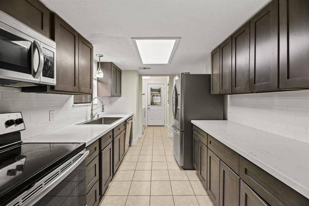 Updated kitchen with quartz countertops and stainless steel appliances!