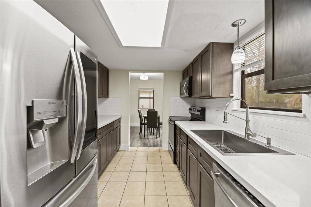 Notice the extra large sink with a window that overlooks the spacious back yard.
