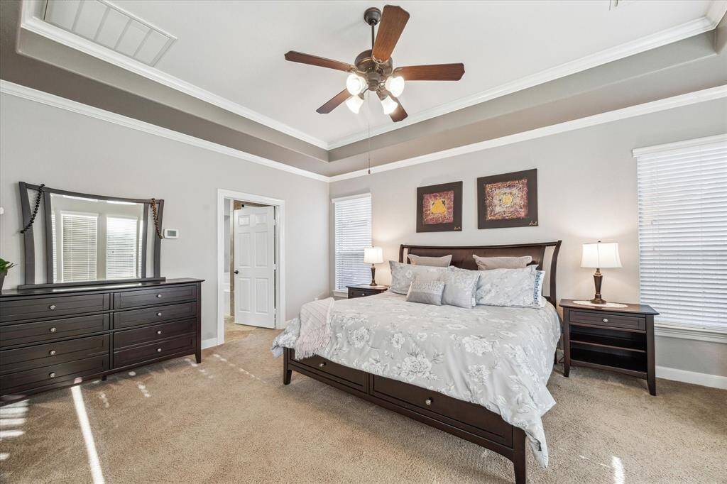 Natural light streams in through two windows, creating a bright and inviting atmosphere.