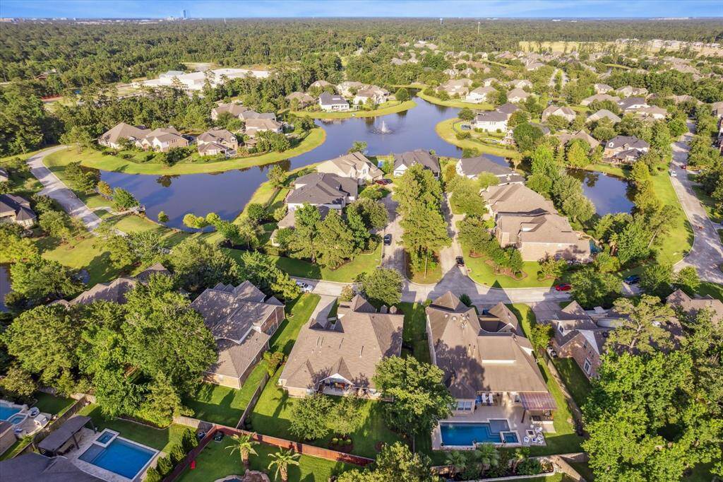 A picturesque neighborhood with spacious homes surrounded by lush greenery and serene water features. Tree-lined streets, offering a tranquil and inviting setting.