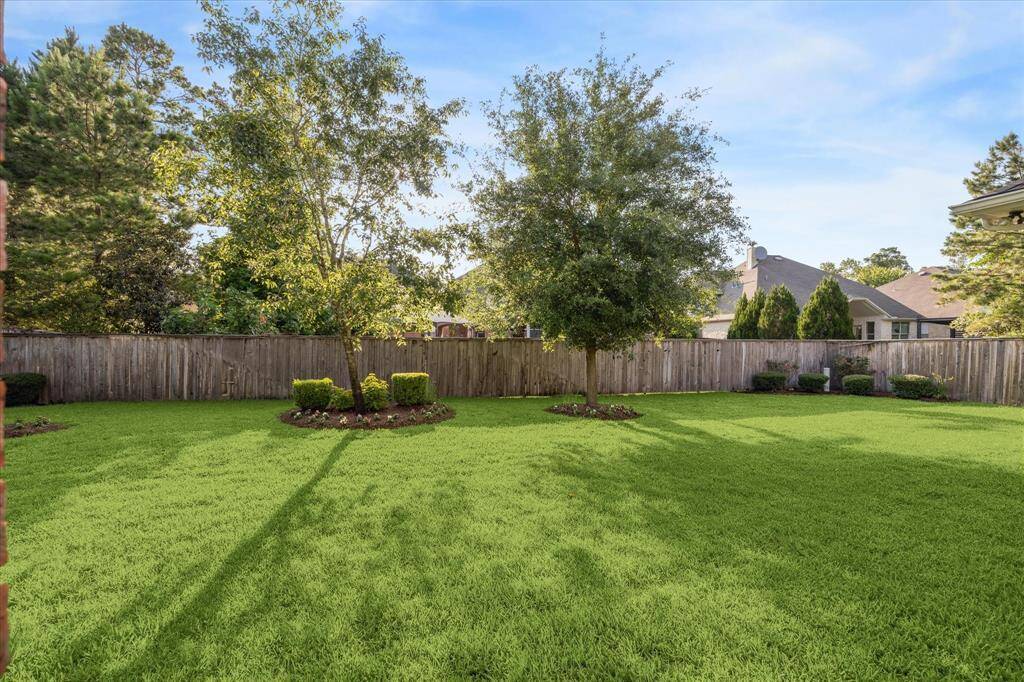 Spacious backyard with well-maintained green lawn. Ideal for outdoor activities and relaxation.