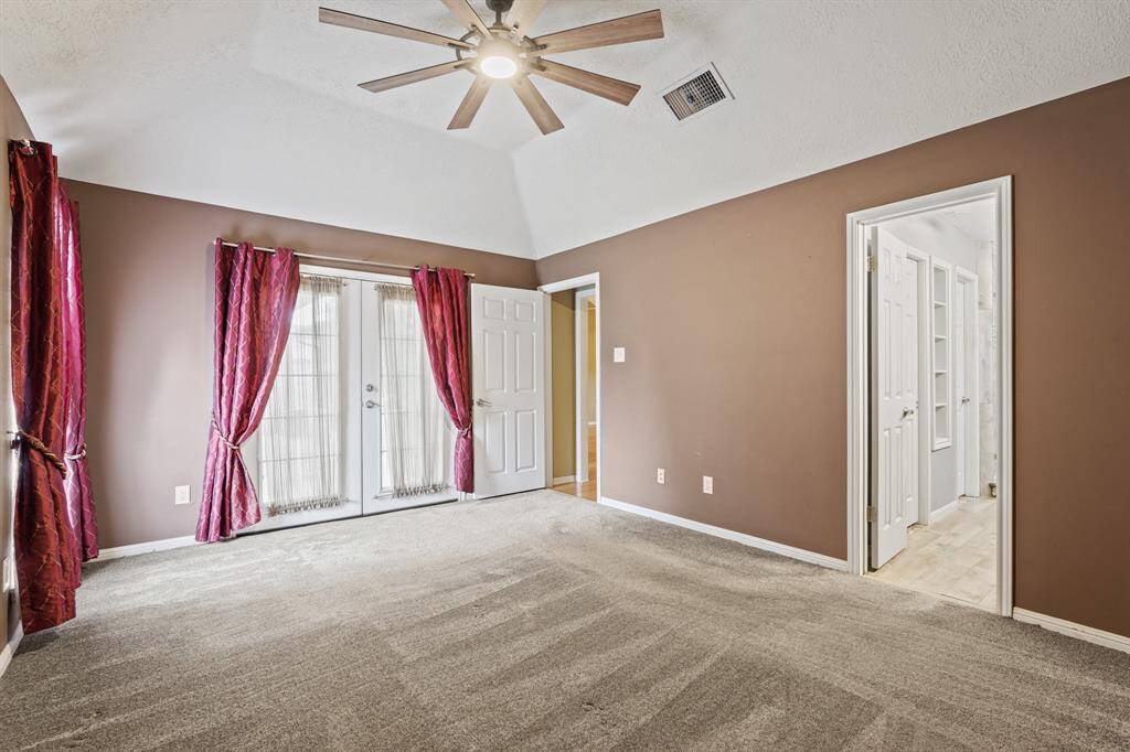 Primary bedroom with high ceilings