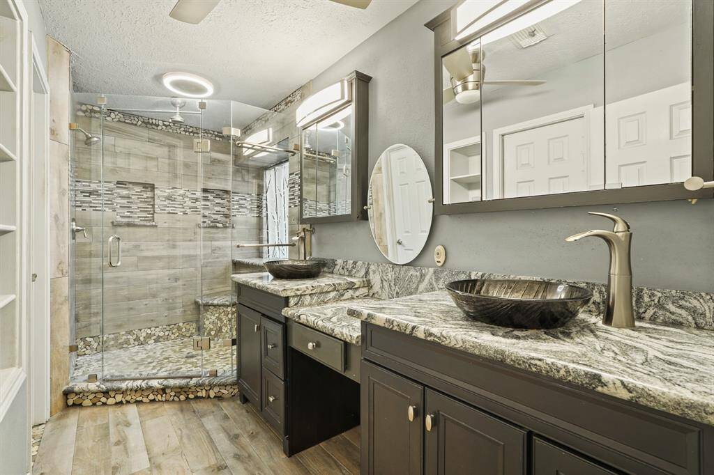 Hall bath with granite counter and updated tile