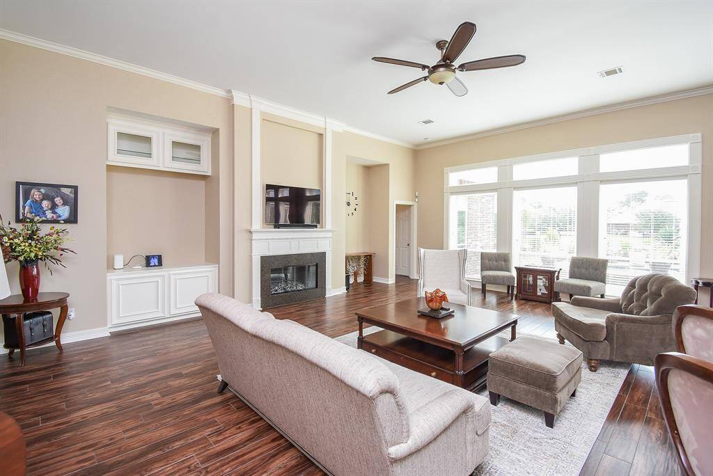 Windows line the entire back of this prestigious gathering place.  Fireplace has been completely updated to include face front of fireplace to high end quartz, changed gas logs to glass stones, added remote control and added glass doors.  It is fabulous while burning.