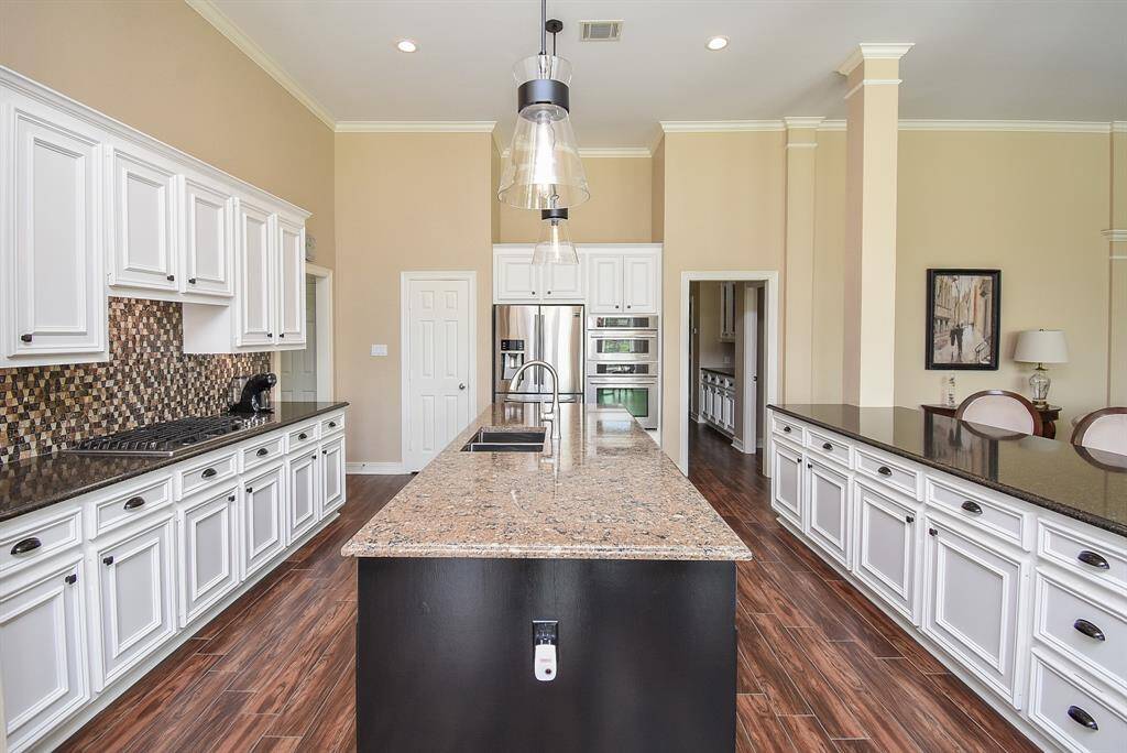 Completely updated and exquisite. High end quartz counters, all backsplash updated with luxury tile, all cabinets updated and look at the storage! Everyone will want to help you cook in this amazing kitchen.