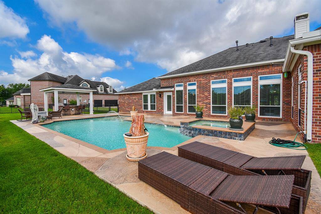 Windows line this home with breathtaking views of the property.
