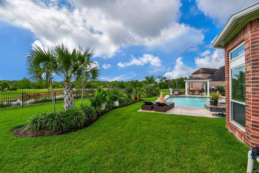 This backyard retreat will greet you every single day.  Serene lake, professionally landscaped, beautiful pool/spa await you and your family.