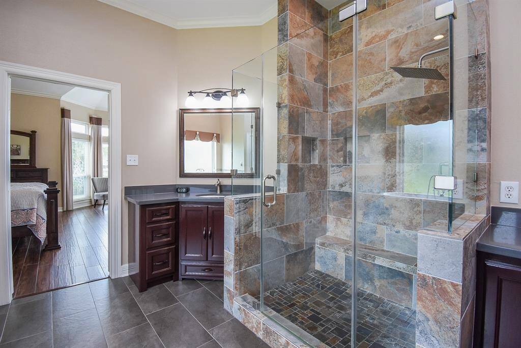 New cabinets, new mirrors ... free standing shower was completely expanded with gorgeous tile, shower bench, updated faucet and seamless doors.
