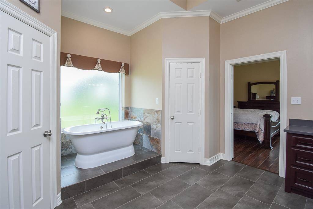 New soaking tub with beautiful faucet, gorgeous wall tile and remodel included step up to stately tub.