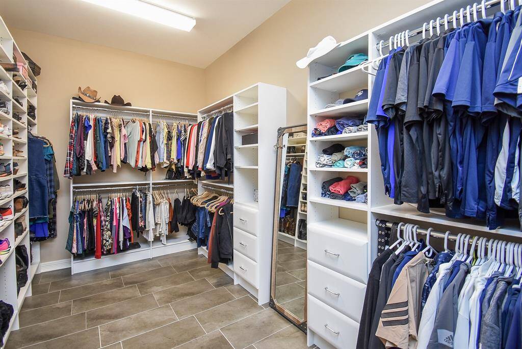 The primary closet was totally gutted to bare walls. Installed built in dressers, drawers, clothes racks, shoe wall for total organization.