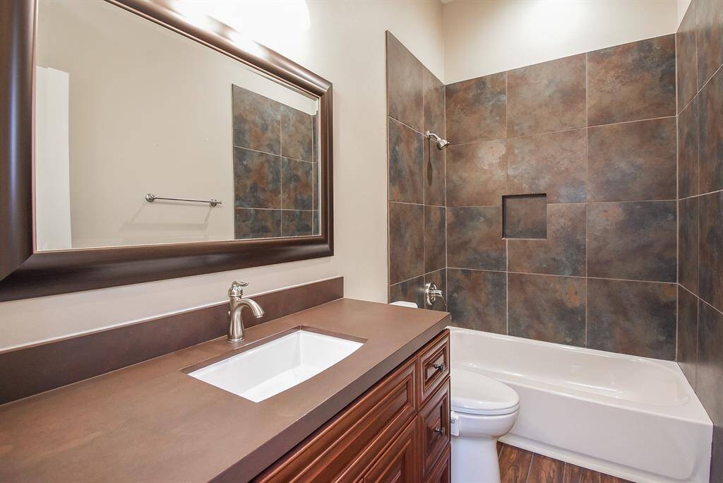 Secondary bathroom has been totally updated.  New vanity cabinet in rich wood, new counter top, new sink, new faucet, new mirror, new hardware ...