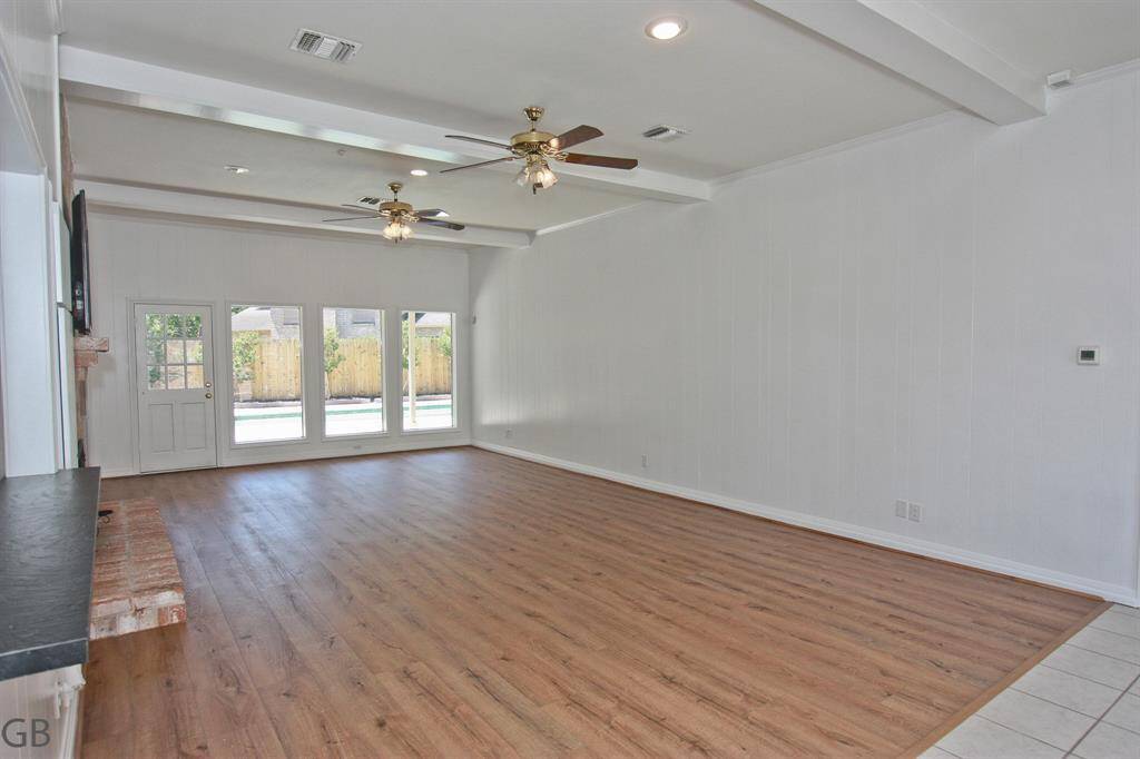 Main Living room. 10 foot ceilings, views both front and back. Access to rear pool area.