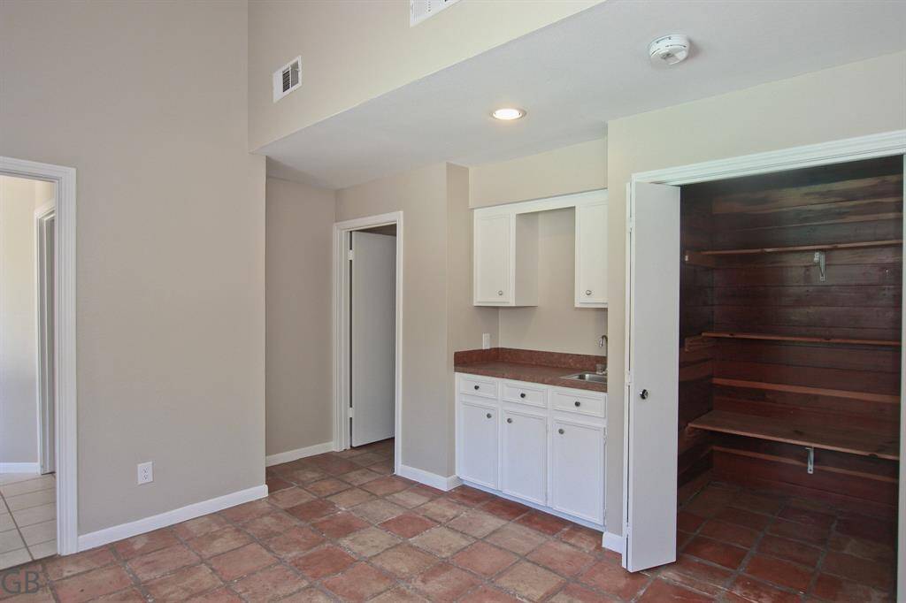Additional climate-controlled storage off back hallway with garage access.