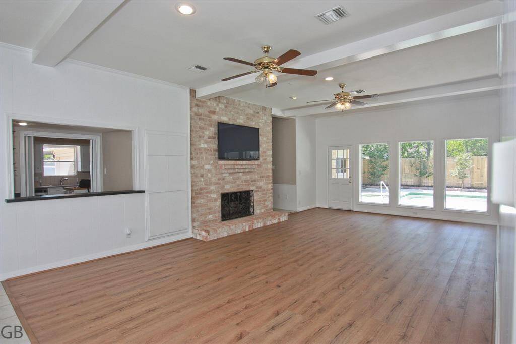 Kitchen, 10 foot ceilings here too, island, window at sink to side yard/driveway.