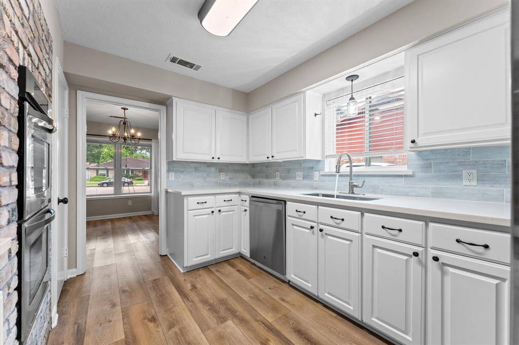 Updated modern kitchen with stainless steel appliances, quartz countertops, ample cabinetry, open to both the breakfast and dining room!