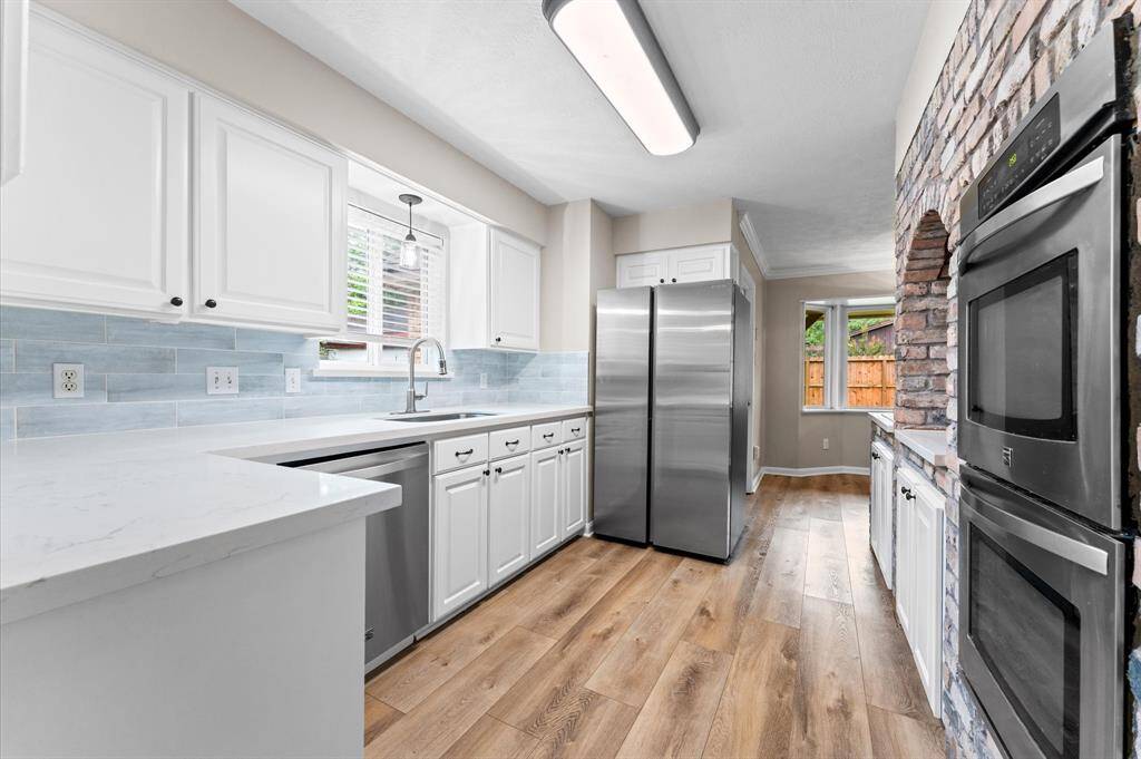 Luxury vinyl flooring flows throughout the kitchen.