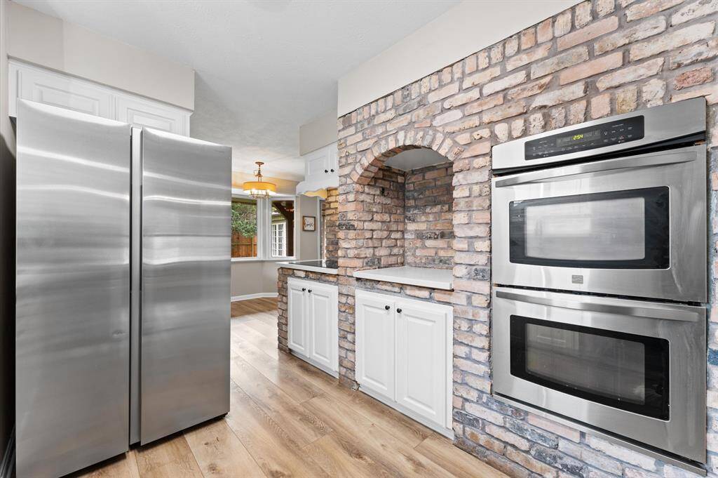Charming brick accent wall and stainless steel appliances.