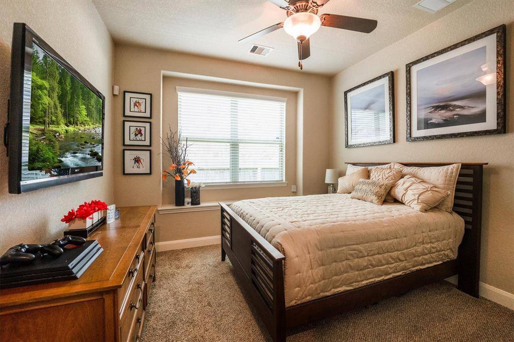 Bedroom No. 1: Bright and inviting bedroom featuring a large window, modern ceiling fan, and fresh paint.