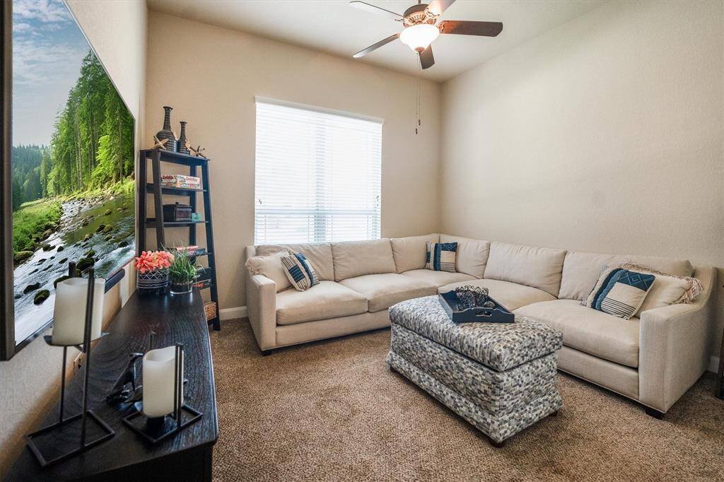 Spacious Bedroom 2: currently a cozy TV room, features a large closet for ample storage.
