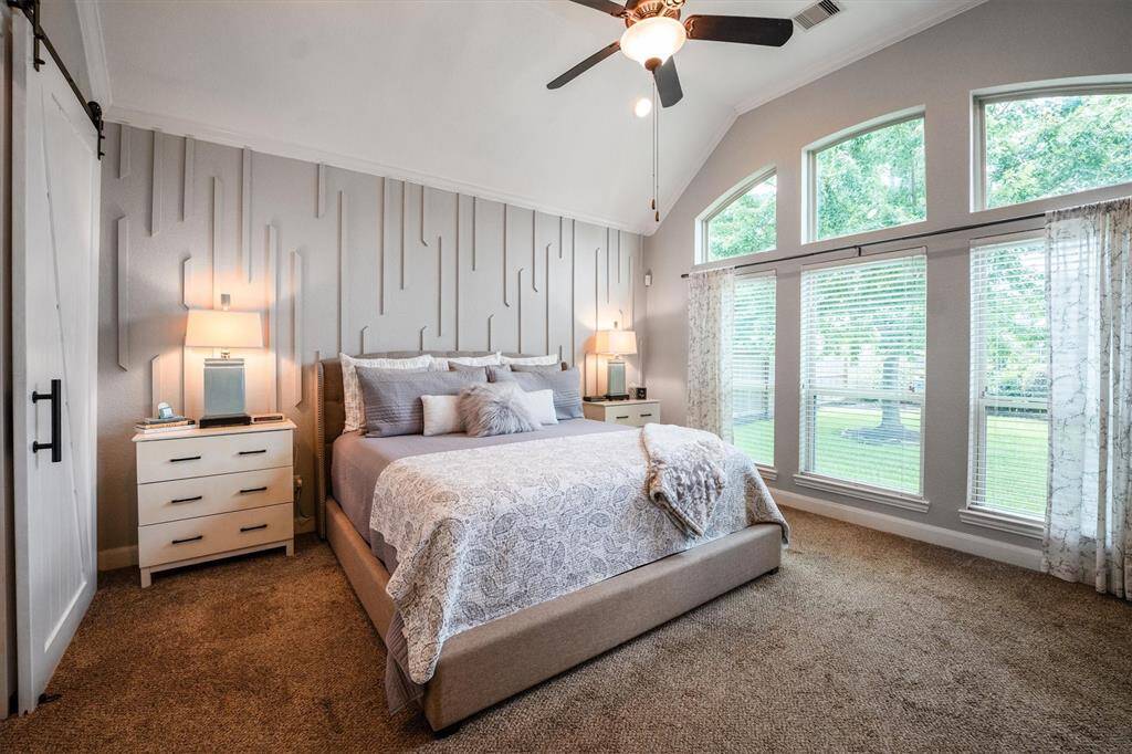 Fabulous primary suite featuring a stylish accent wall and abundant natural light.