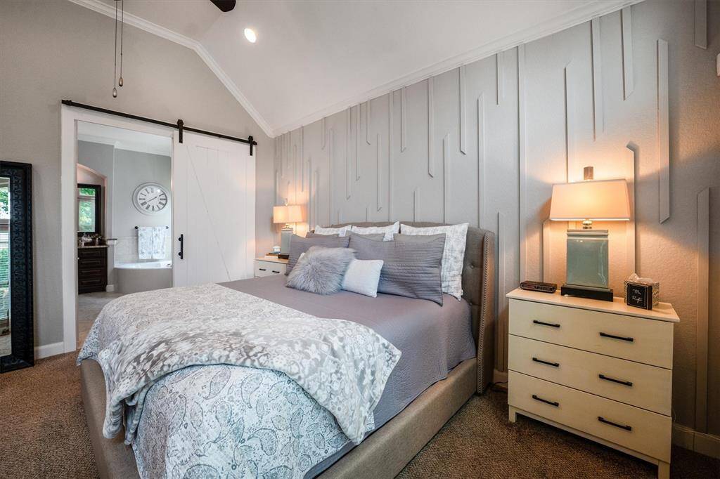 Stylish upgraded barn door enhances the primary bath entrance.