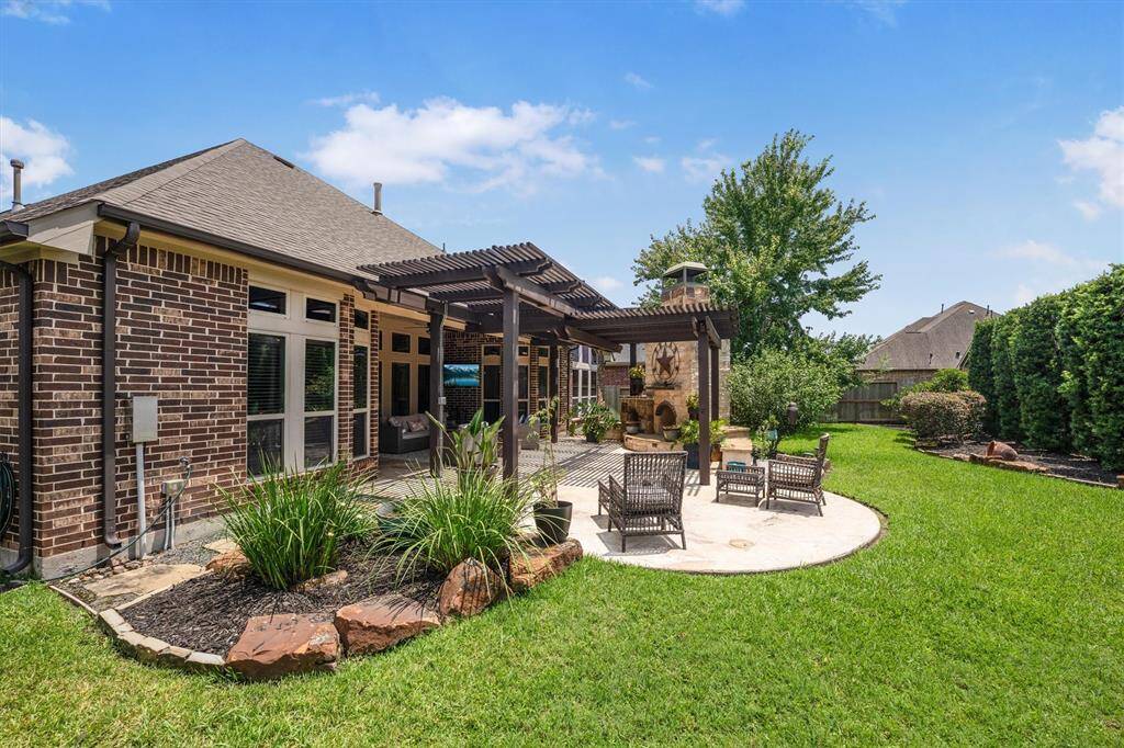 This expansive patio is perfect for entertaining and relaxation, accommodating all your outdoor furniture needs.